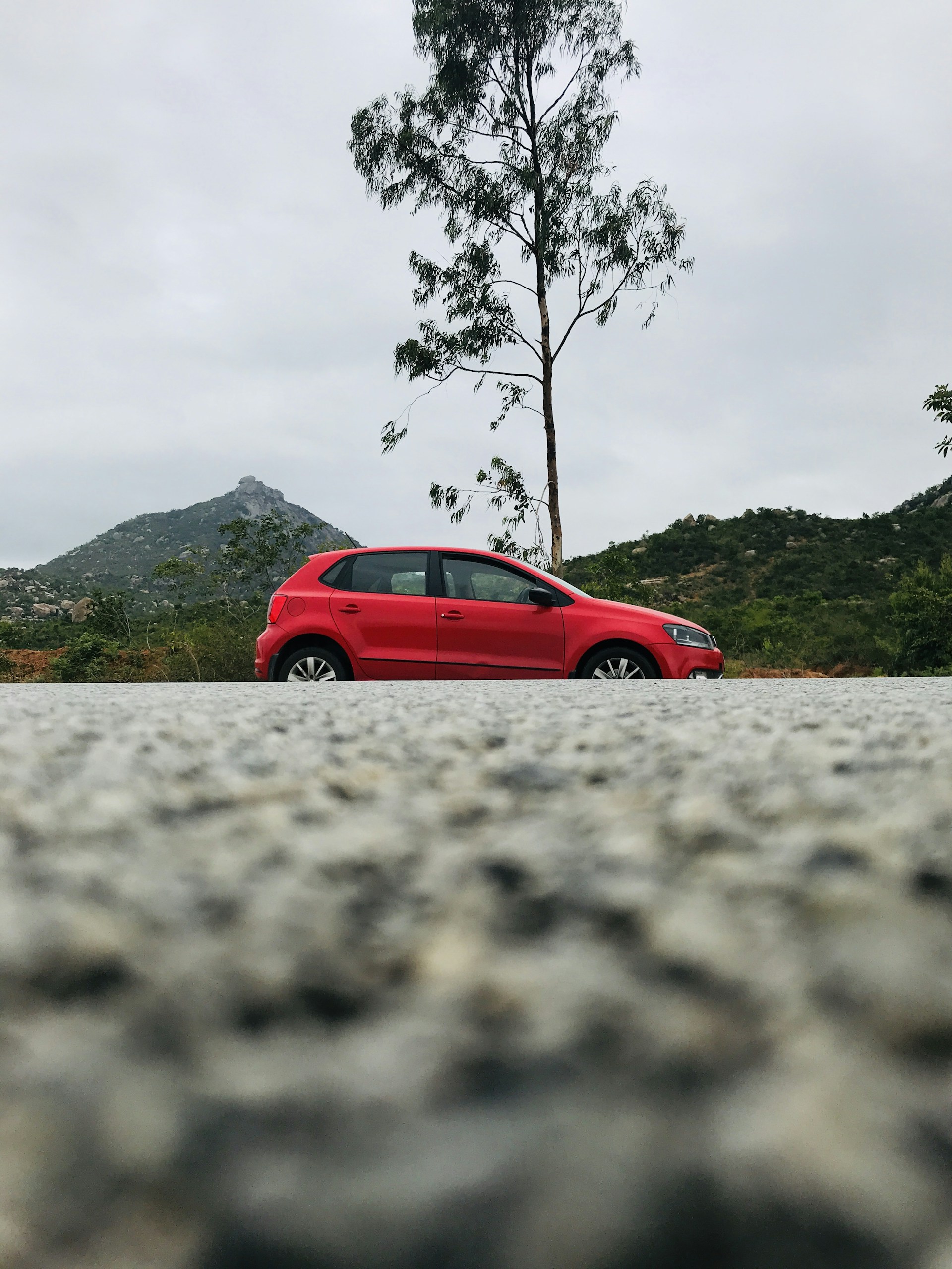 red 5-door hatchback near tree