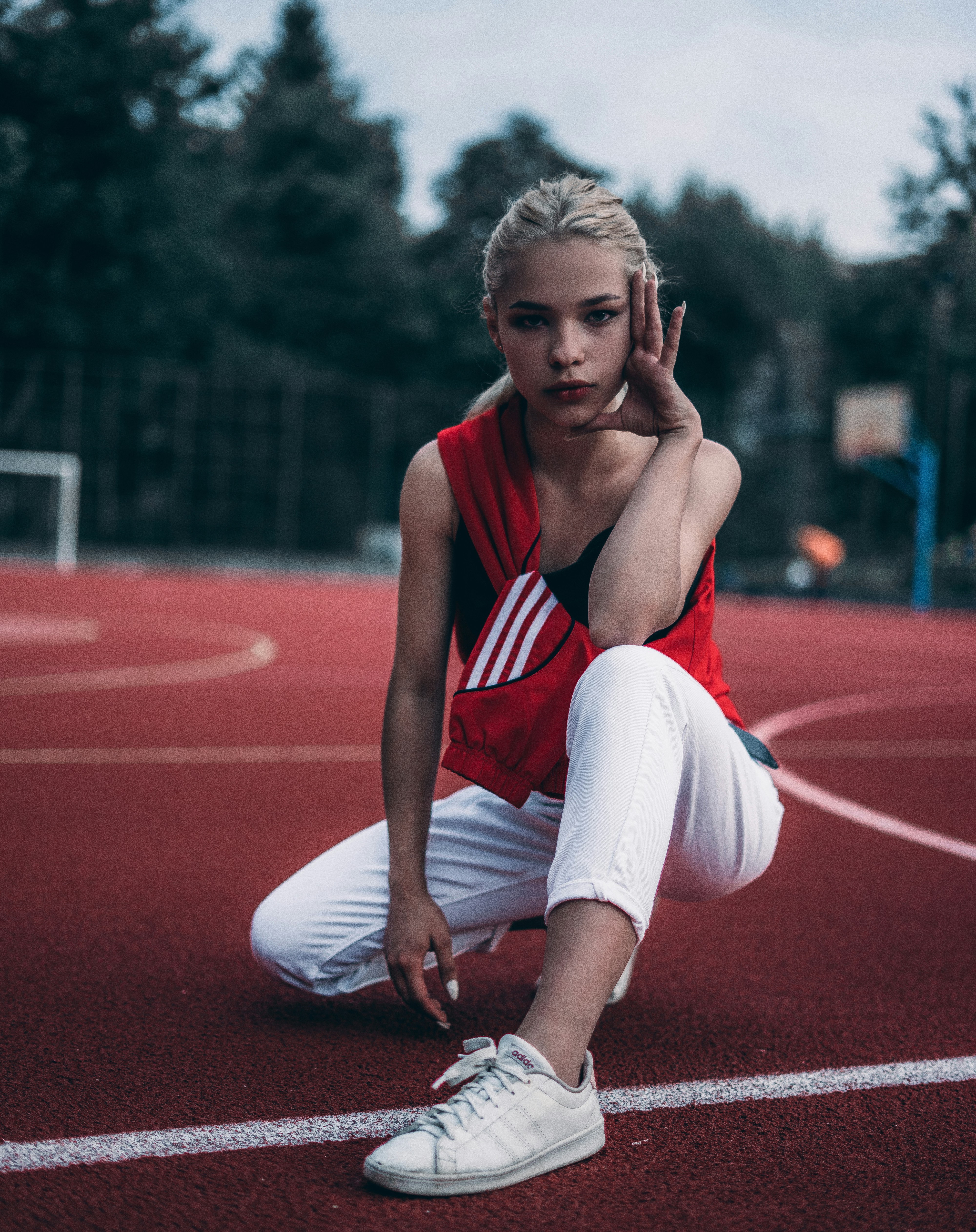 woman crouching on track field