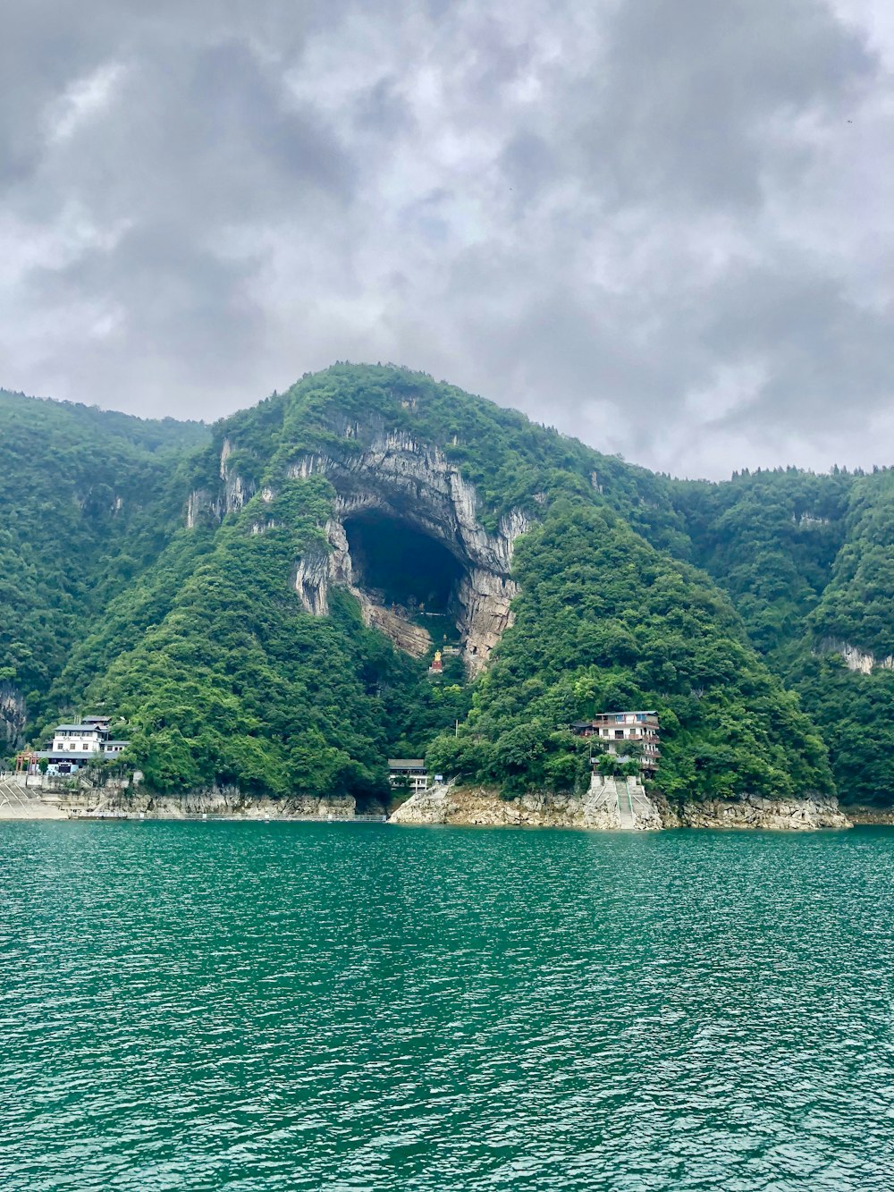 houses on sea cliff during daytime