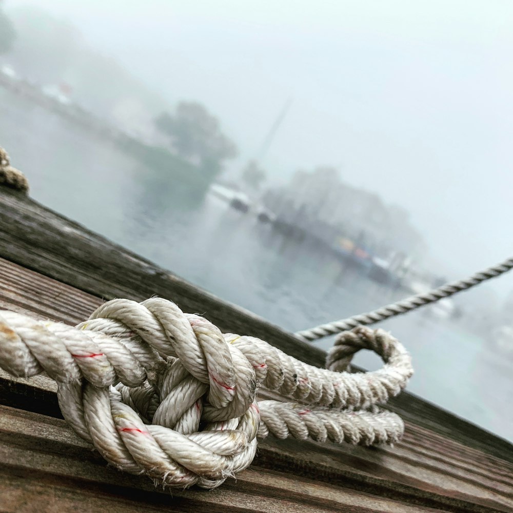 knotted gray rope on brown surface