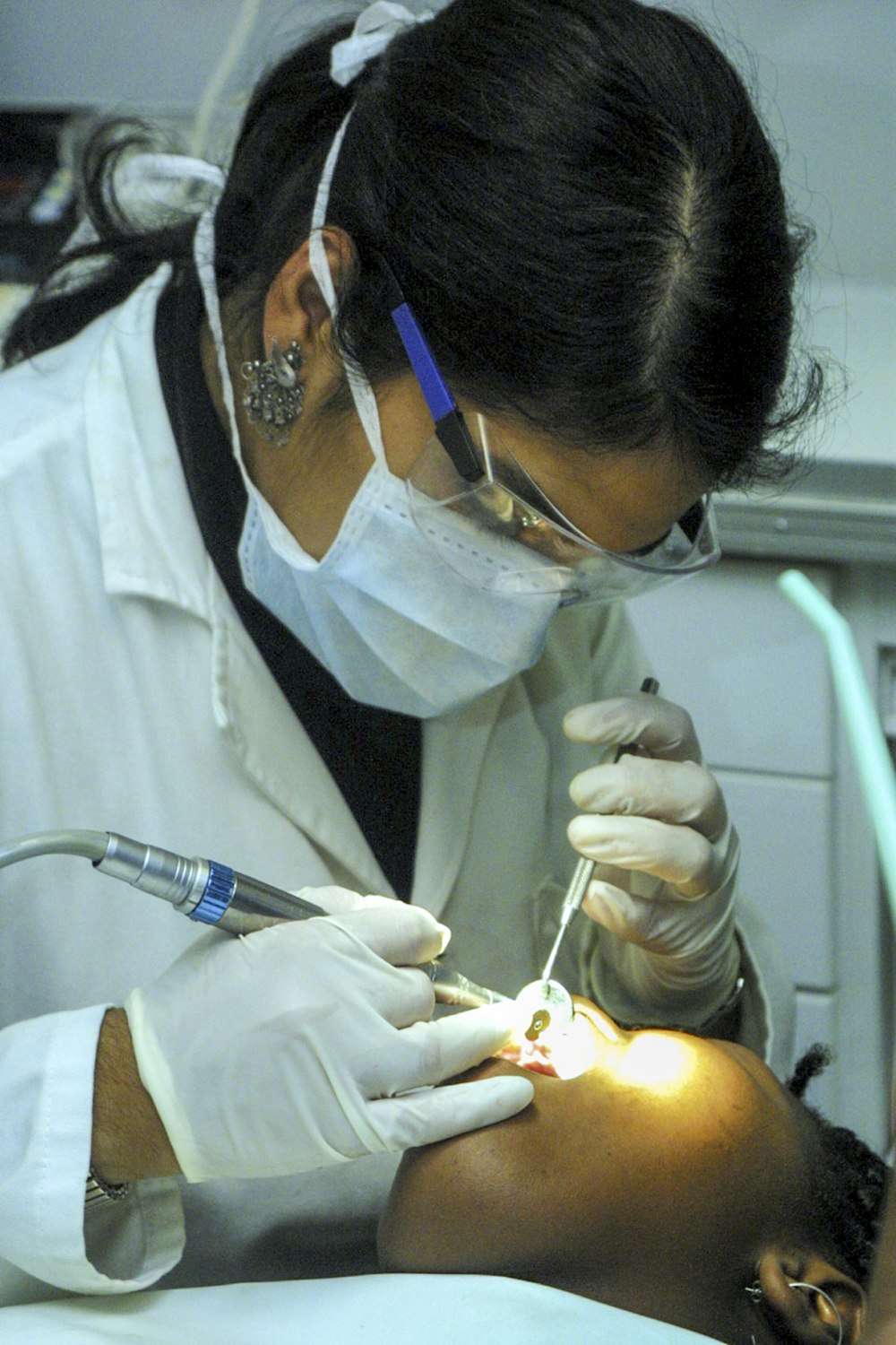 woman holding dentist mirror