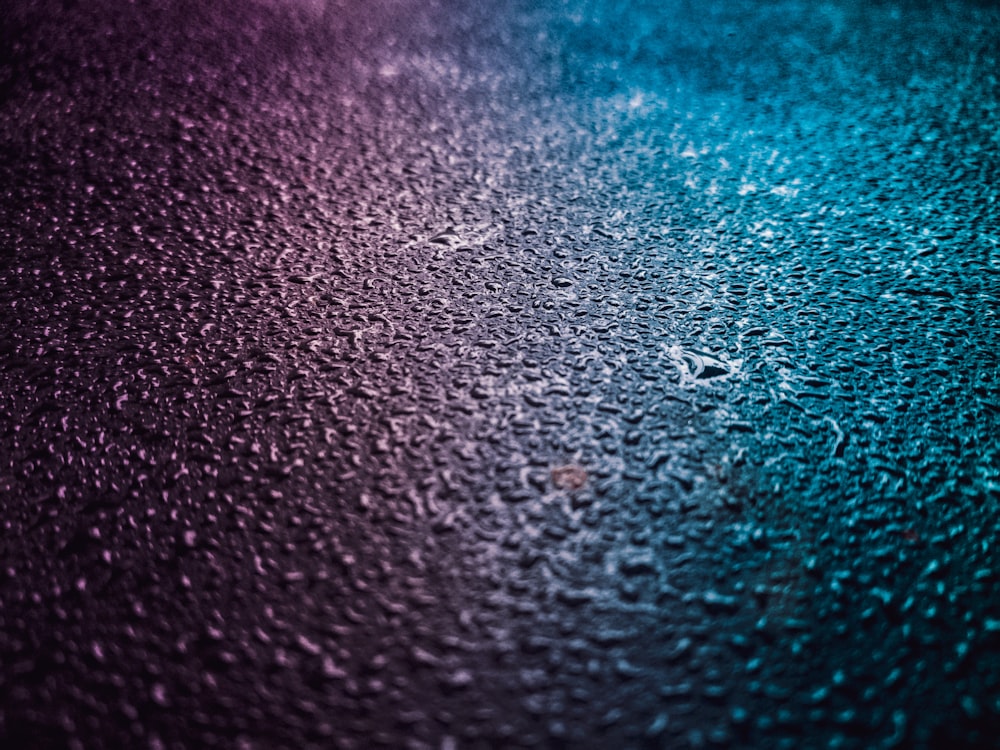 blue and purple lights reflecting on wet floor