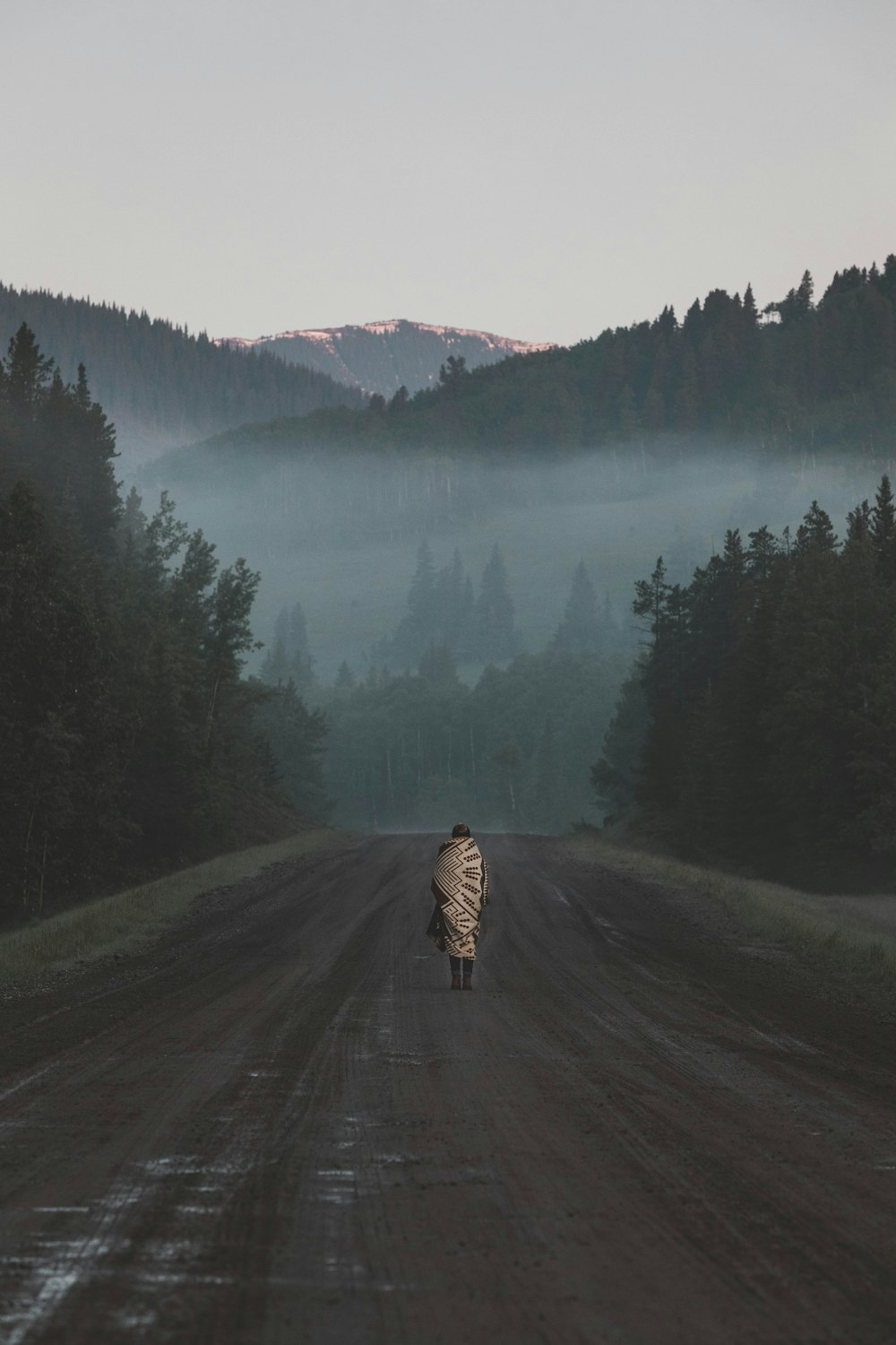 person standing in the middle of road