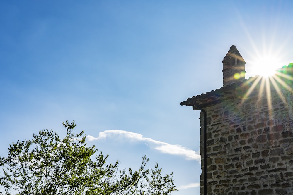 the sun shines brightly over a stone building