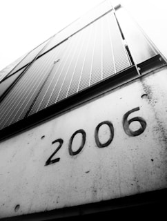a black and white photo of a building with the number 2006 written on it