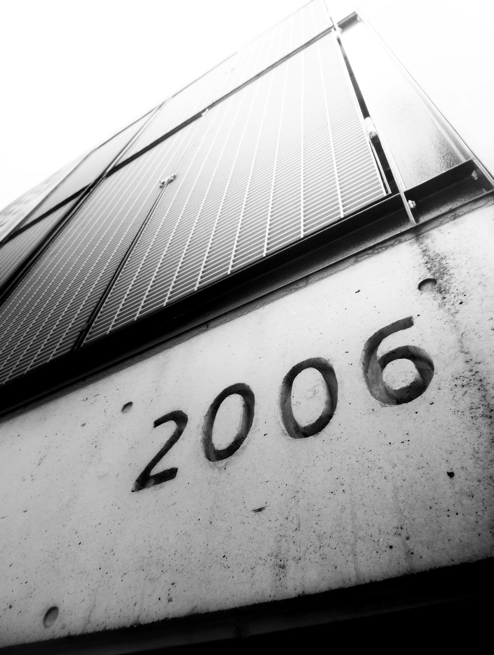 a black and white photo of a building with the number 2006 written on it