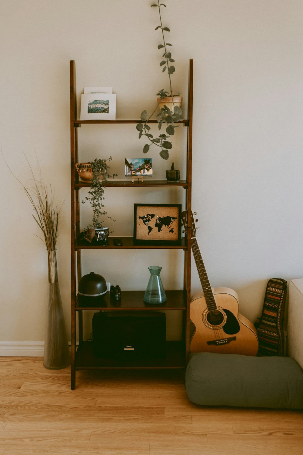 brown wooden 5-layer rack beside dreadnought guitar