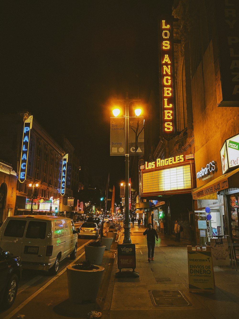 man walking on sidewalk at night