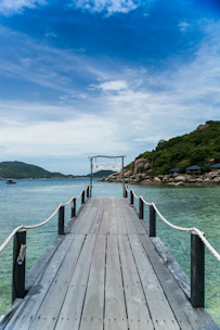 The calm pier of Lobos Island with clear turquoise waters under a bright sky.