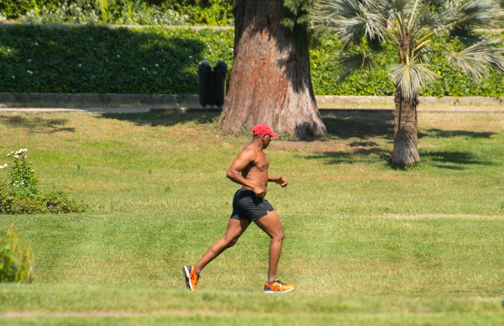 men running in a grass field during daytime