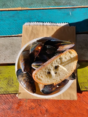 A rustic setting featuring mussels and a variety of flavorful sauces.