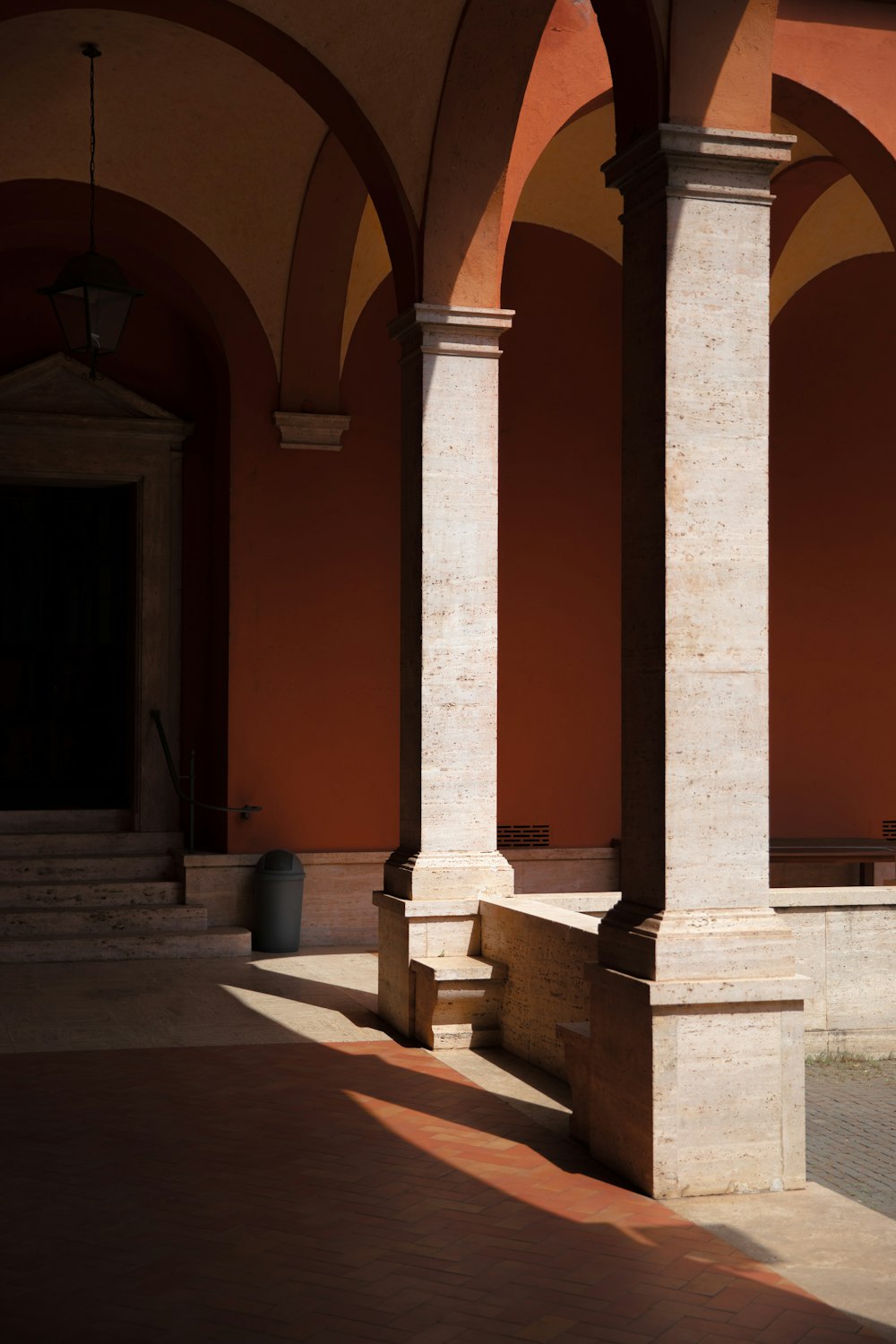 a building with columns and a bench in front of it