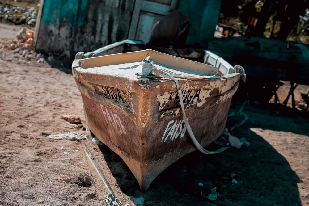 brown and white wooden boat in beach