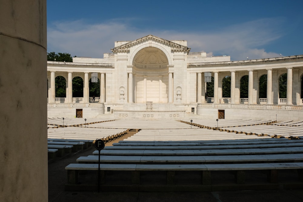 a large white building with a bunch of benches in front of it