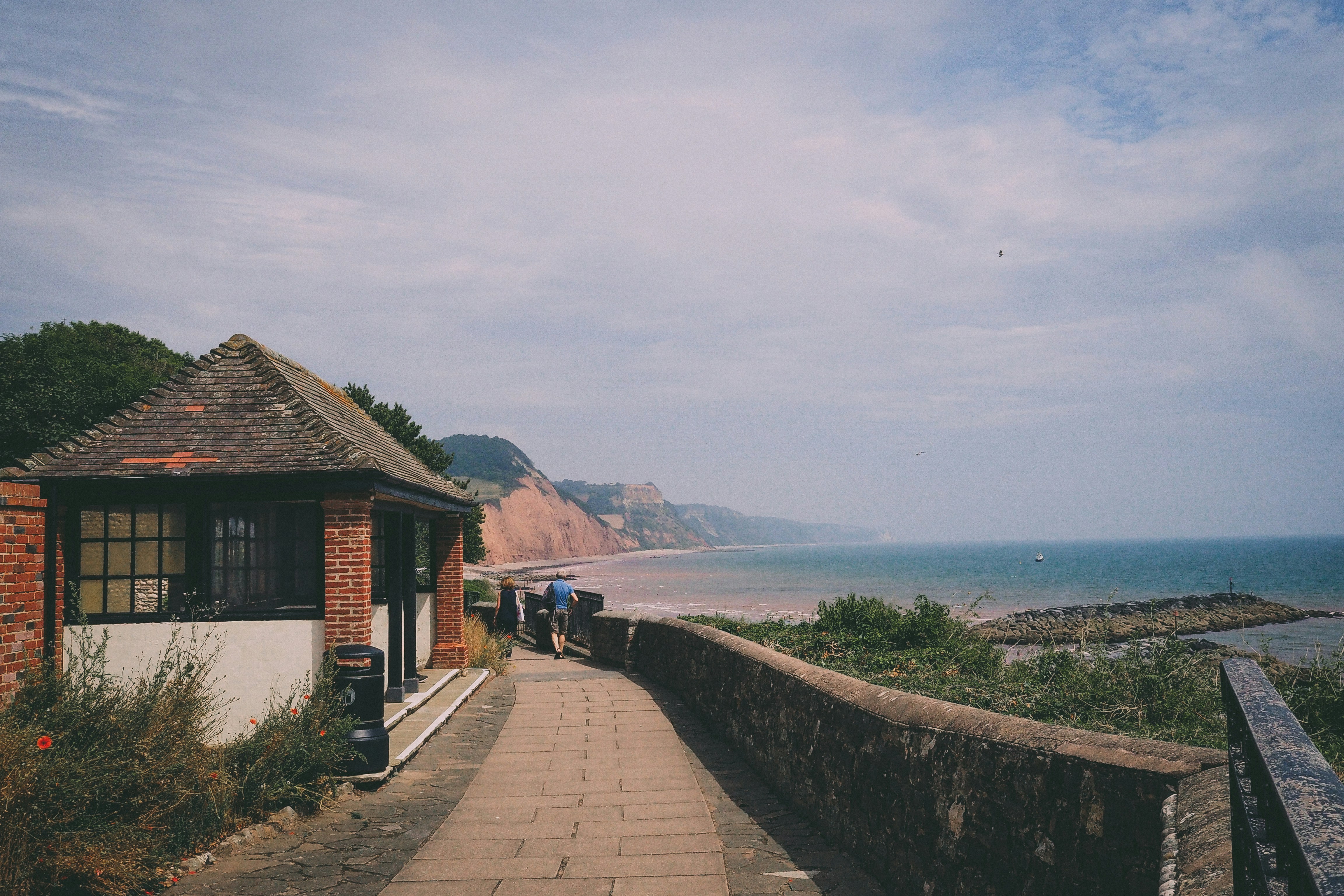 a walkway leading to a beach next to the ocean