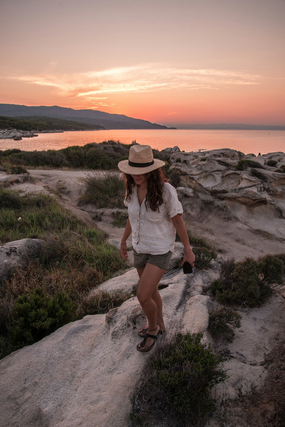 woman standing on rocks