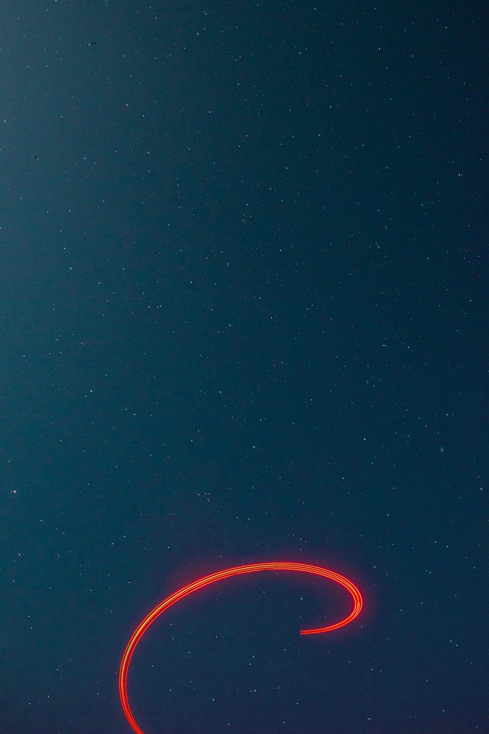 a red object is flying in the sky