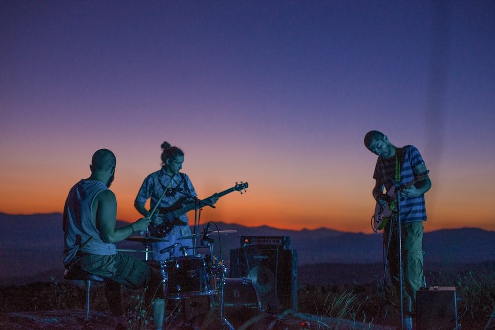 a group of people that are playing guitars