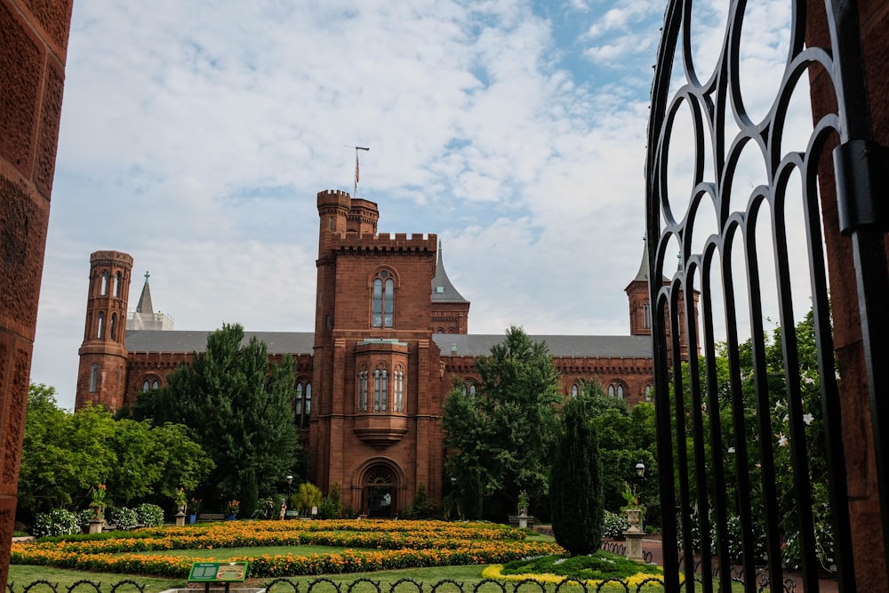 a view of a building through an iron gate