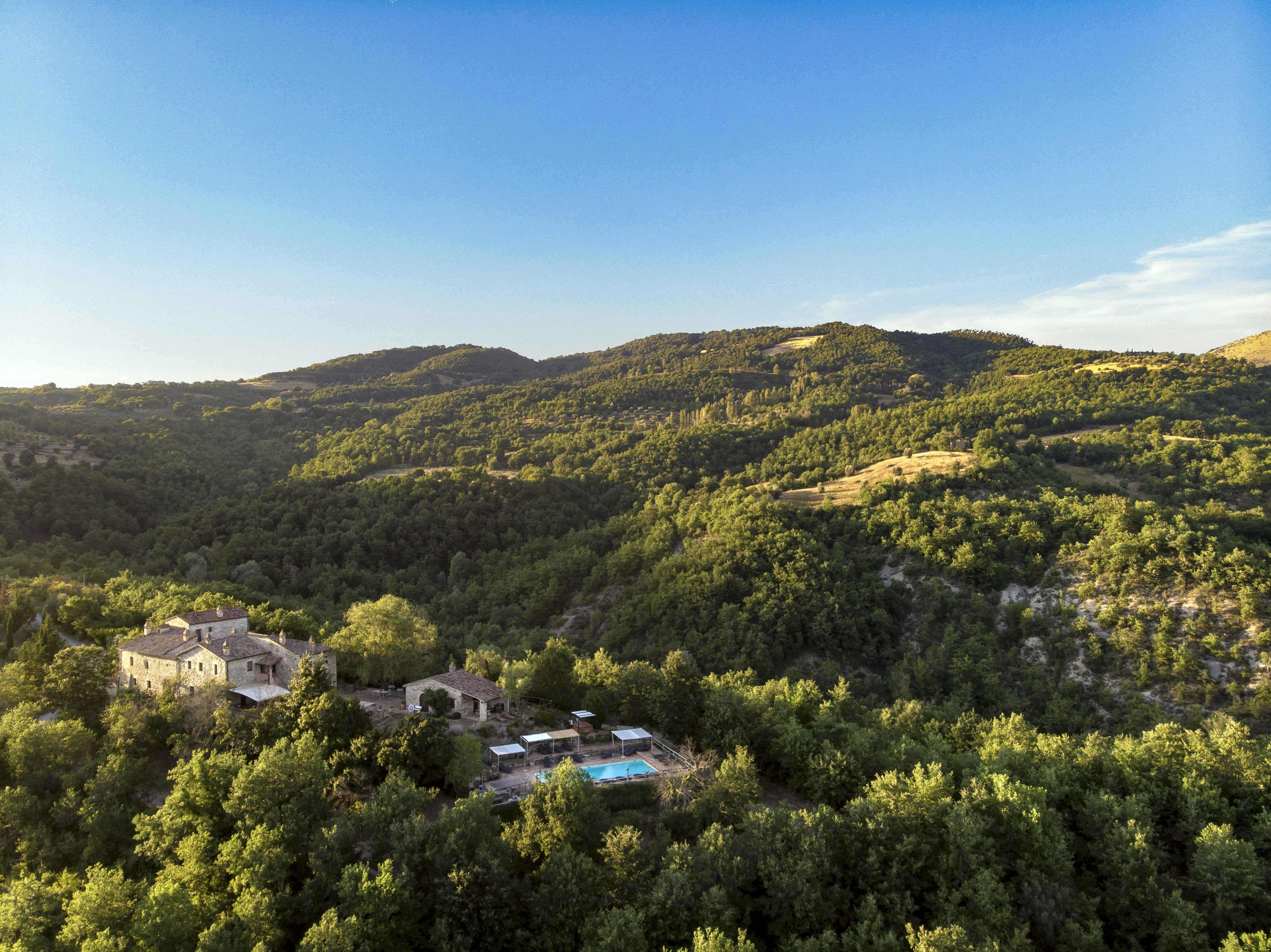 buildings near hill under blue sky during daytime, 