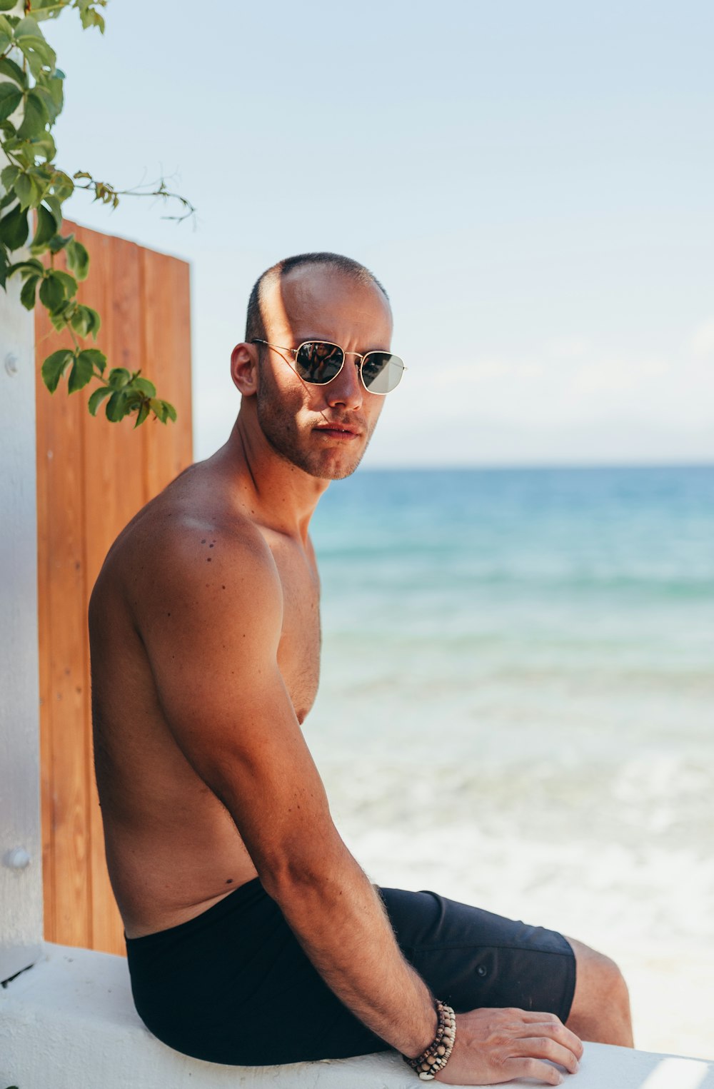 man sitting on white wooden frame