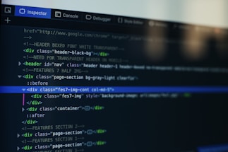 A computer screen displays a code editor with HTML code. The interface has a dark theme with syntax highlighting in various colors. Menu options like Inspector and Console are visible at the top.