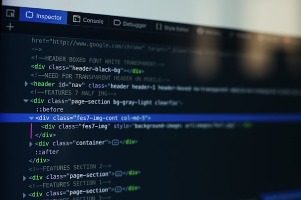 A computer screen displays a code editor with HTML code. The interface has a dark theme with syntax highlighting in various colors. Menu options like Inspector and Console are visible at the top.