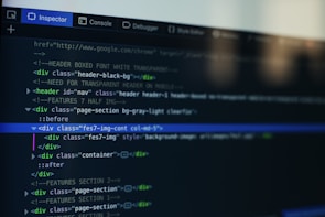 A computer screen displays a code editor with HTML code. The interface has a dark theme with syntax highlighting in various colors. Menu options like Inspector and Console are visible at the top.