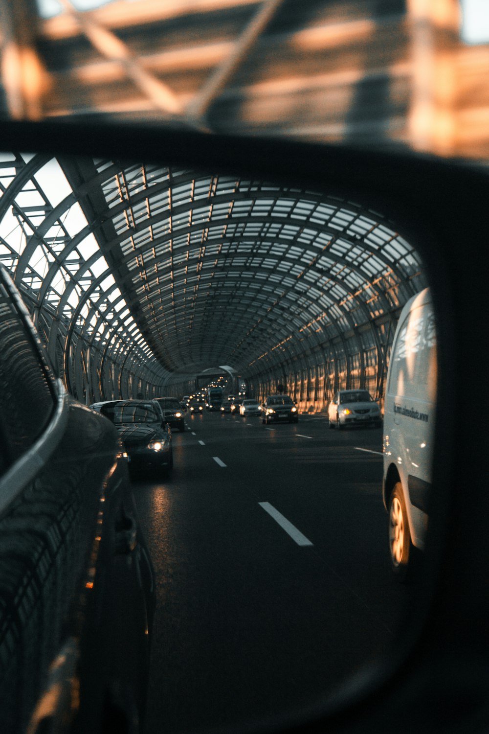 different vehicles on road view from side mirror