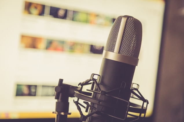 A microphone set against a soft-focus background, symbolizing voice recording.