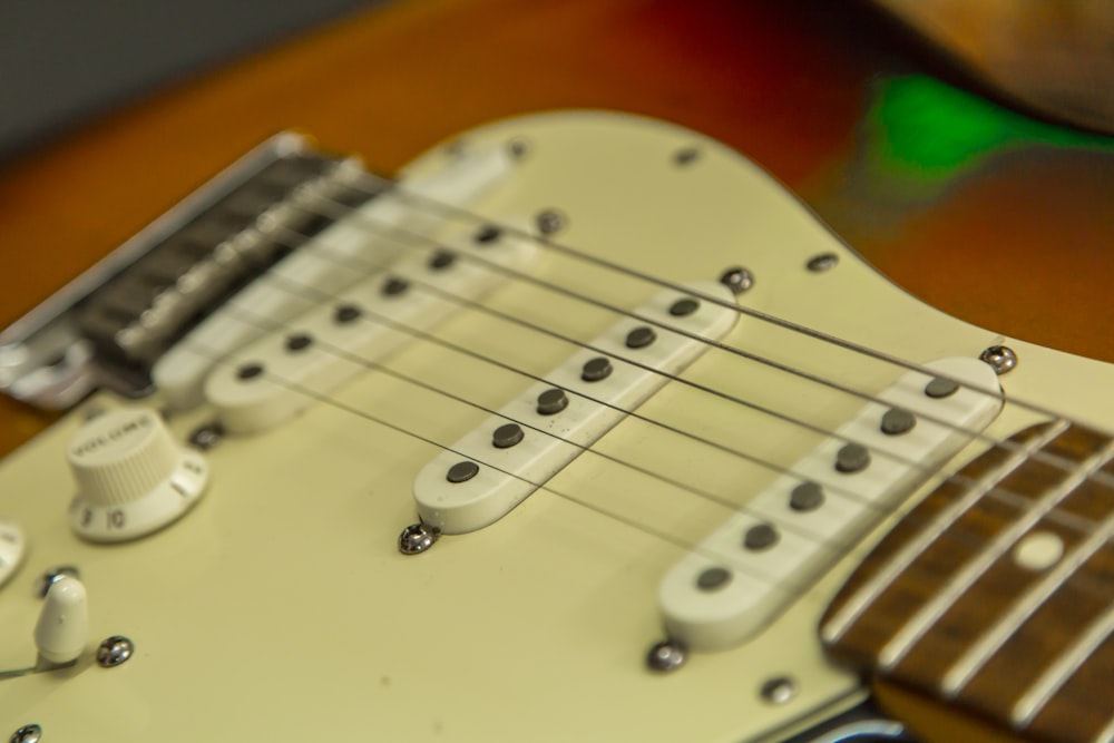 brown and white electric guitar