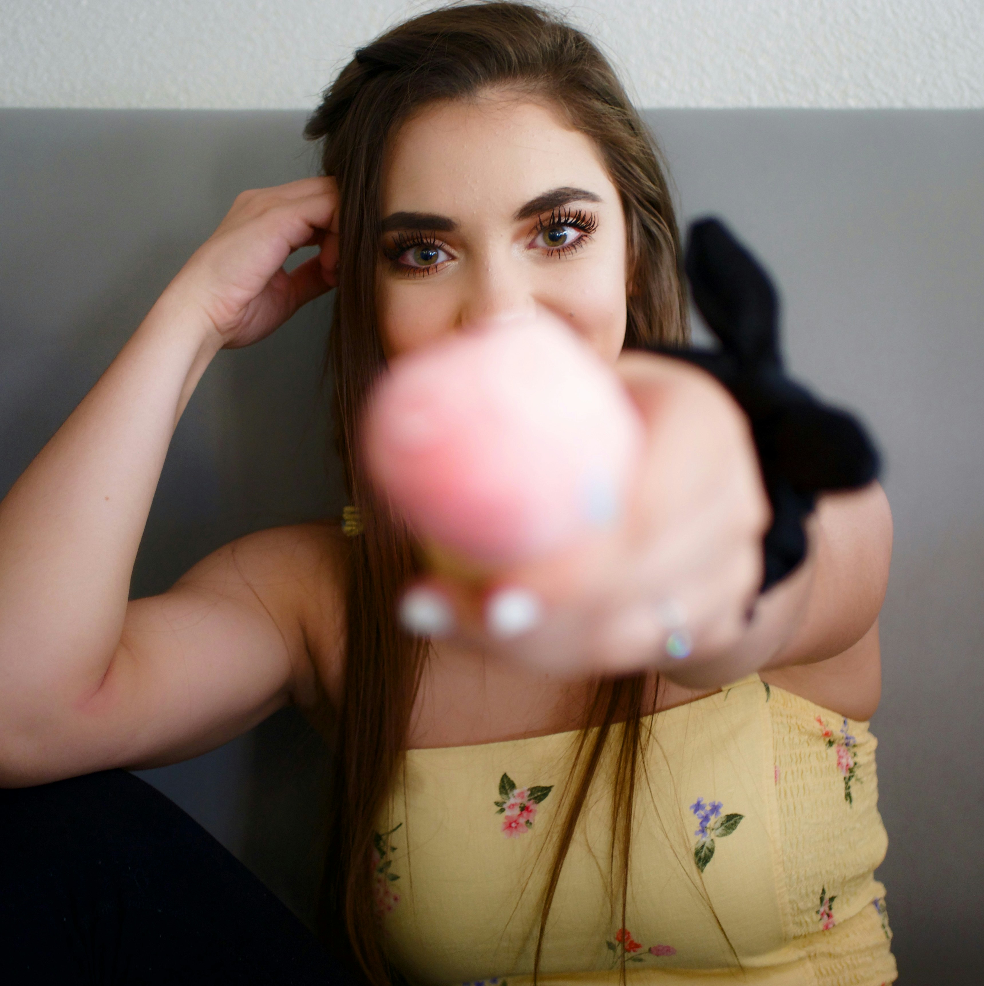 woman wearing yellow floral top
