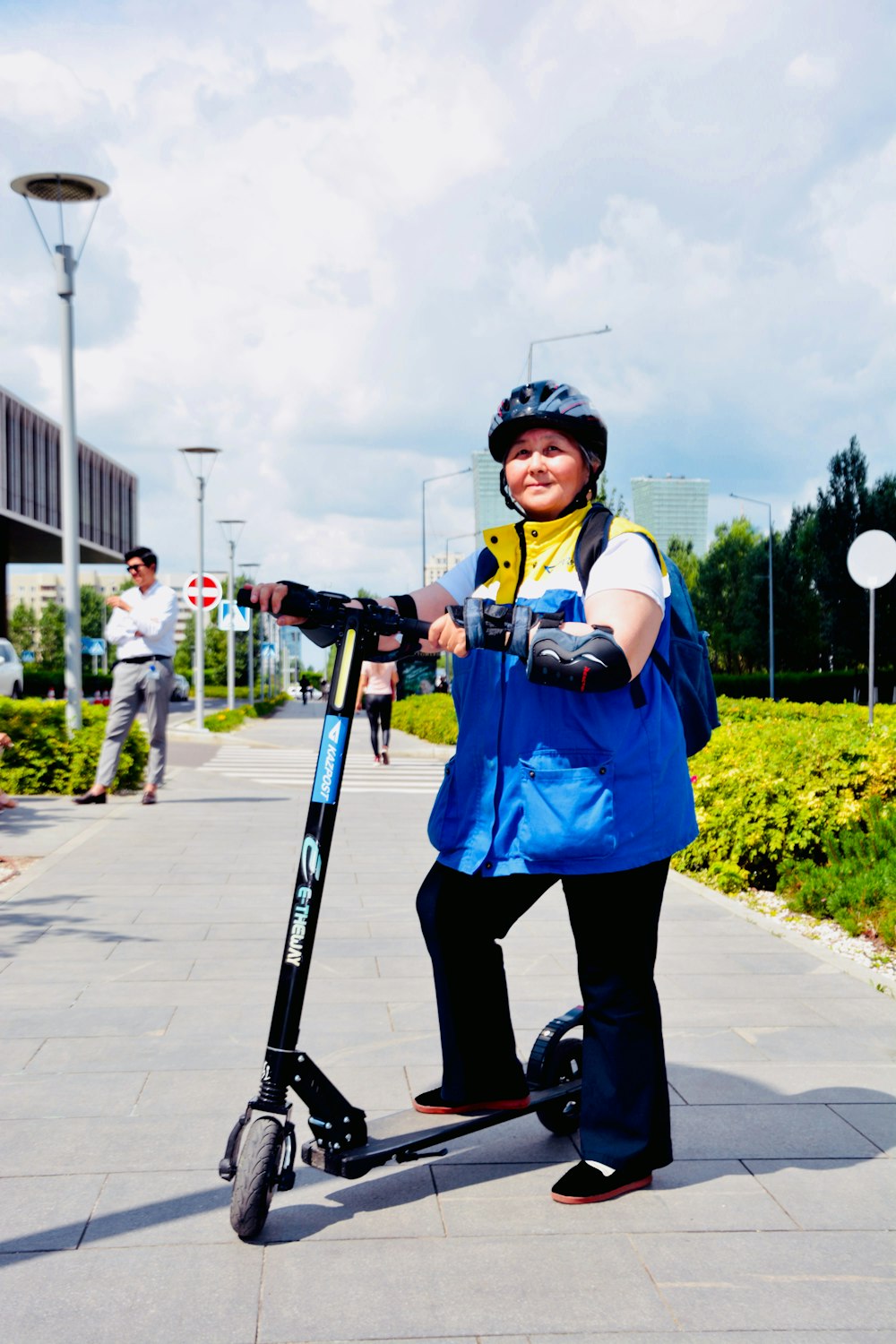 woman standing beside kick scooter