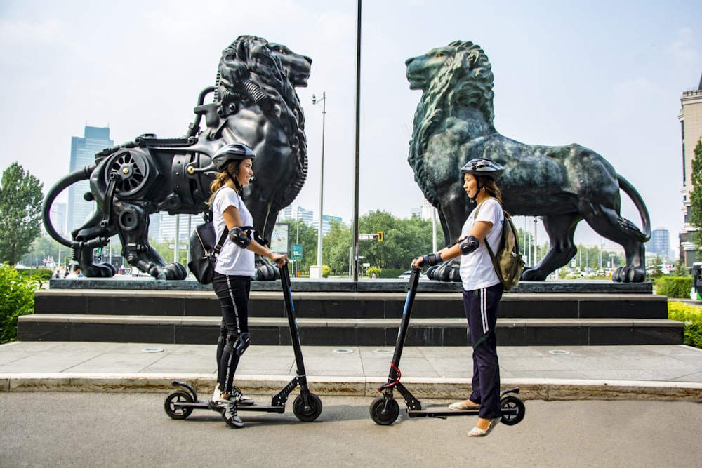 woman standing beside kick scooter