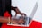 A close-up of a person typing on a laptop with SEO analytics on the screen.
