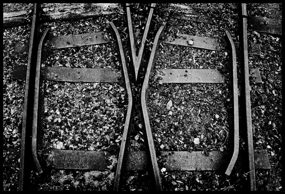 a black and white photo of two train tracks