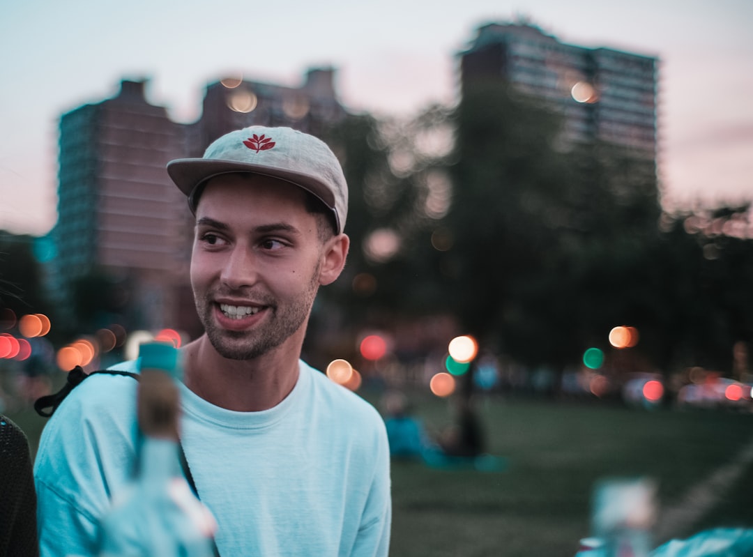 unknown person in white crew-neck top taking selfie outdoors