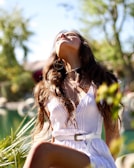 A boho-inspired look with layered accessories and a flowy dress in nature.