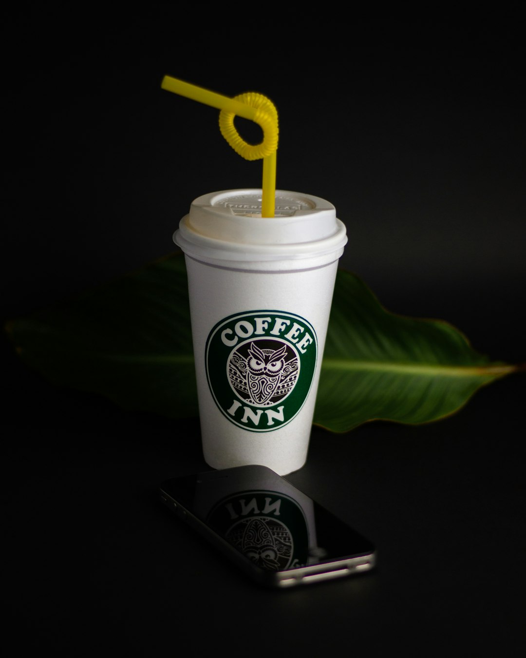 white and green plastic cup