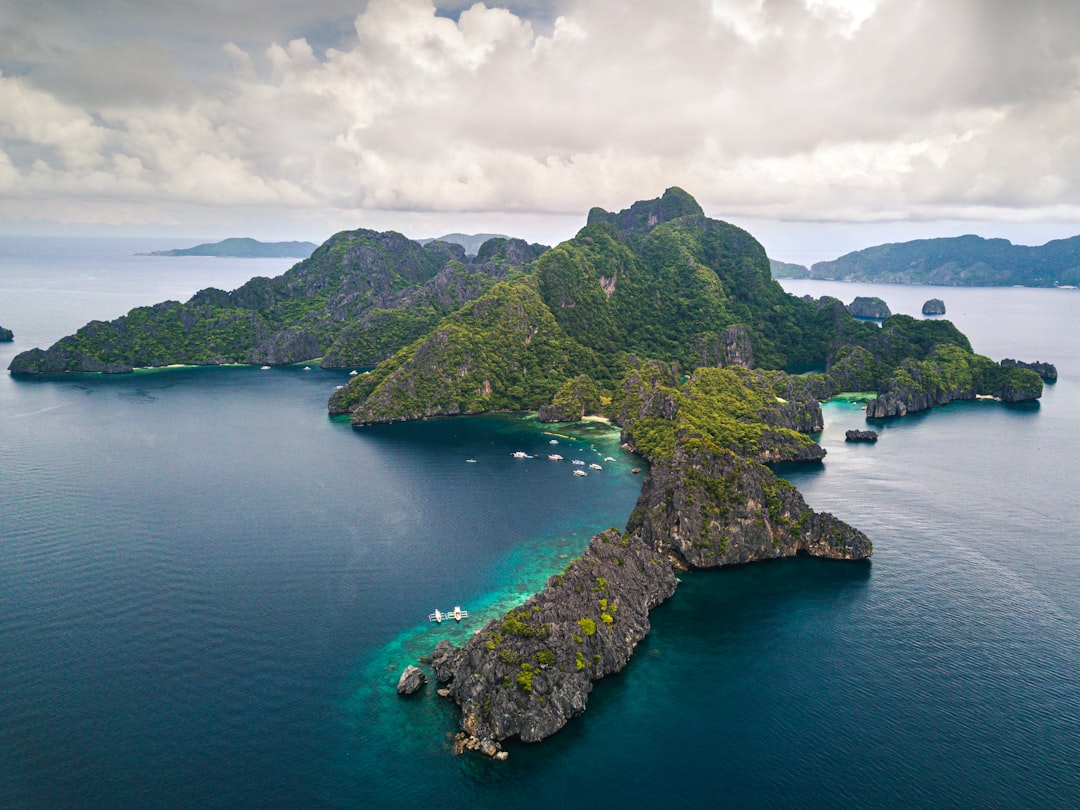 landscape photography of islet, Drone shot of the Twin peaks in the Philippines.