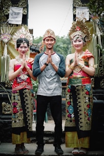 man and two women clasping their hands
