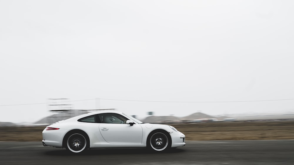 white coupe on road