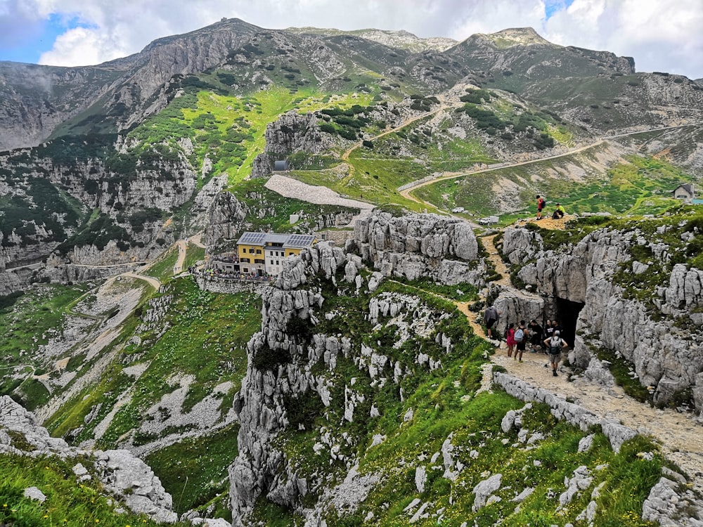 group of people standing near stone cave