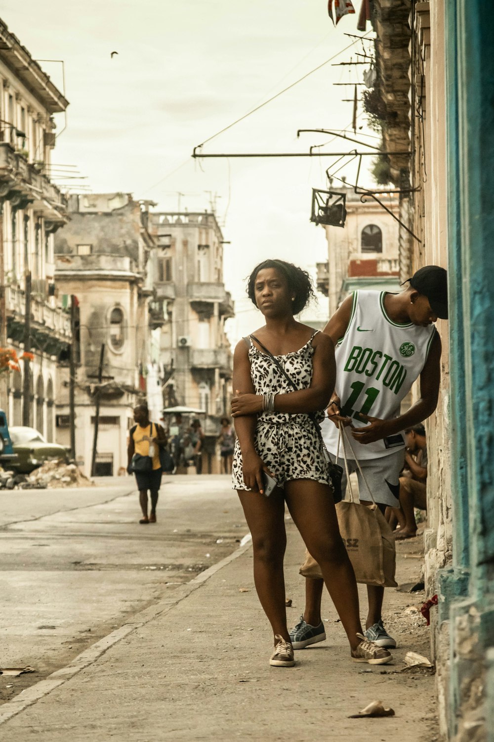 man and woman standing near road viewing buildings