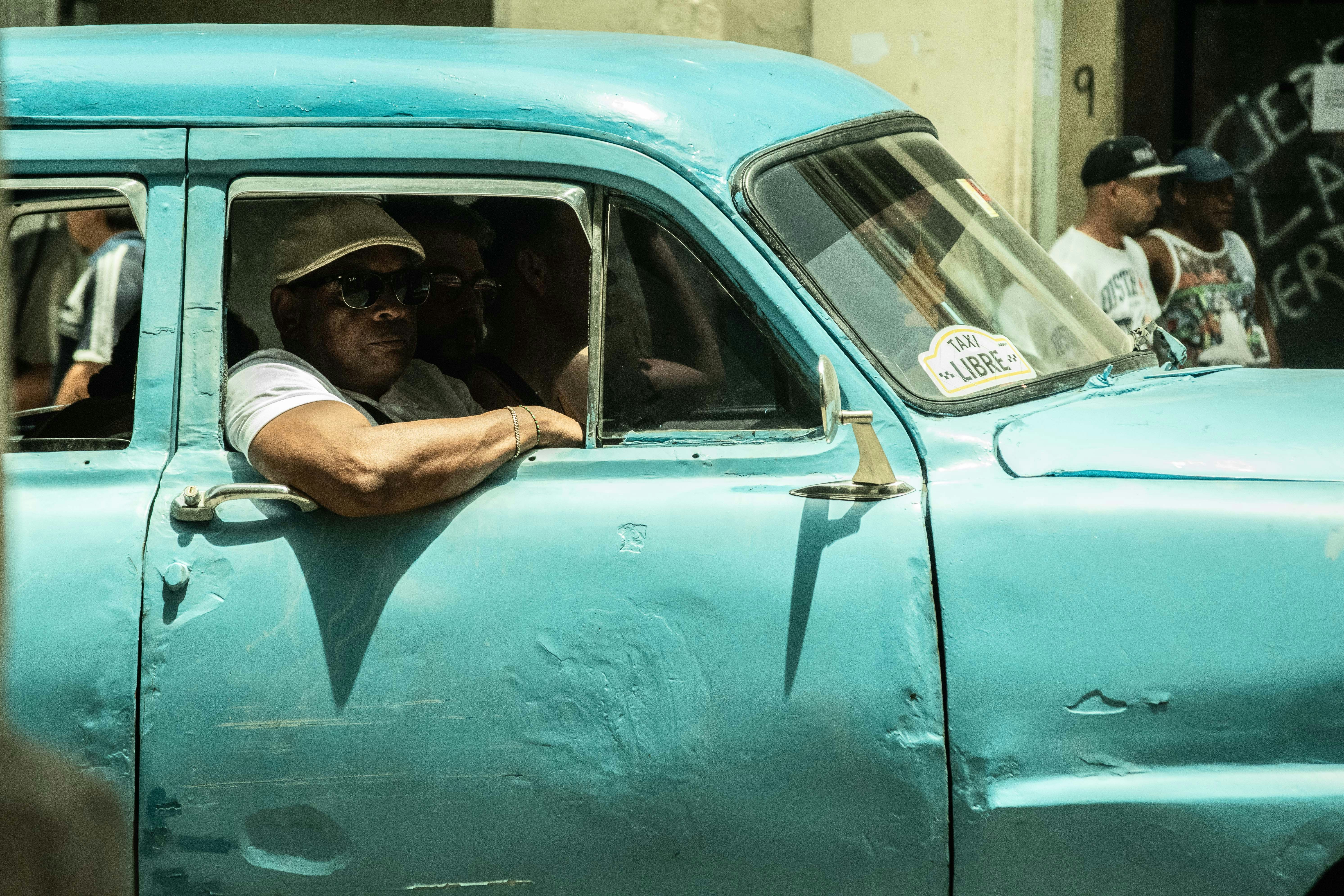 unknown person riding on blue car