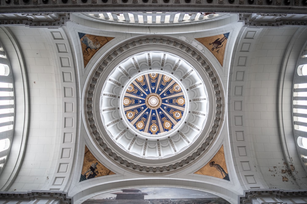 the ceiling of a building with a circular window