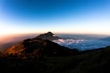 A scenic view of Jeju Island's Seongsan Ilchulbong sunrise peak with clear blue skies.