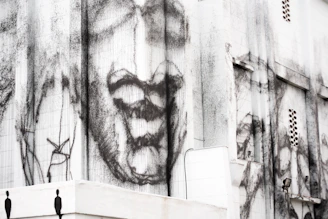 Large-format print being applied on a building facade outdoors.