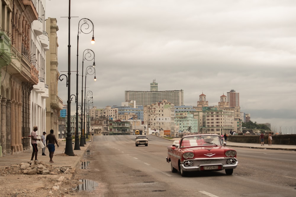 classic red Chevrolet convertible coupe on road