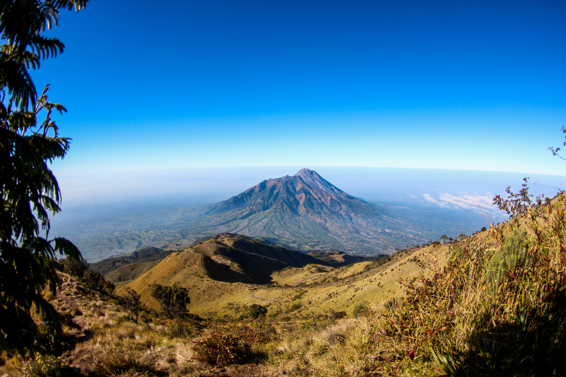 An expansive panoramic image showcasing a serene mountain range under a dramatic sky, emphasizing depth and scale.